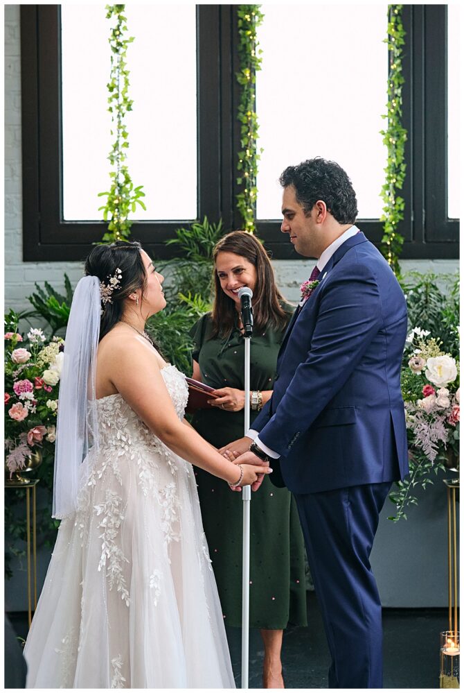 Couple exchanging vows during wedding ceremony.