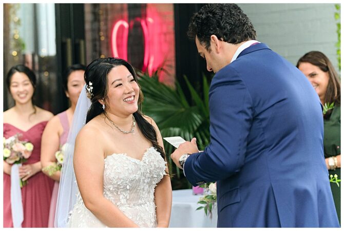Bride and groom exchanging vows at wedding ceremony.