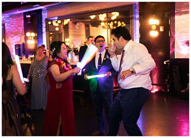 People dancing with glow sticks at a party