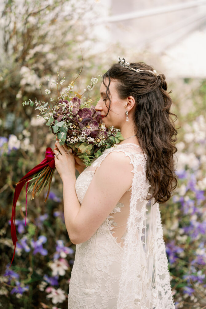 Bride holding a bouquet, surrounded by flowers