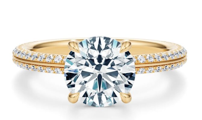 Gold ring with diamond solitaire and pave setting