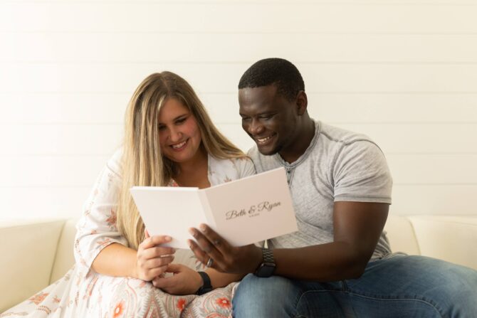 Smiling couple reading a wedding invitation