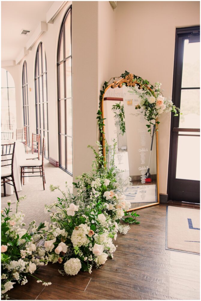 Elegant floral mirror wedding seating arrangement.
