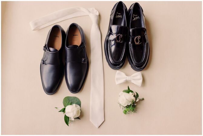 Black dress shoes, white tie, bow tie, boutonnieres.