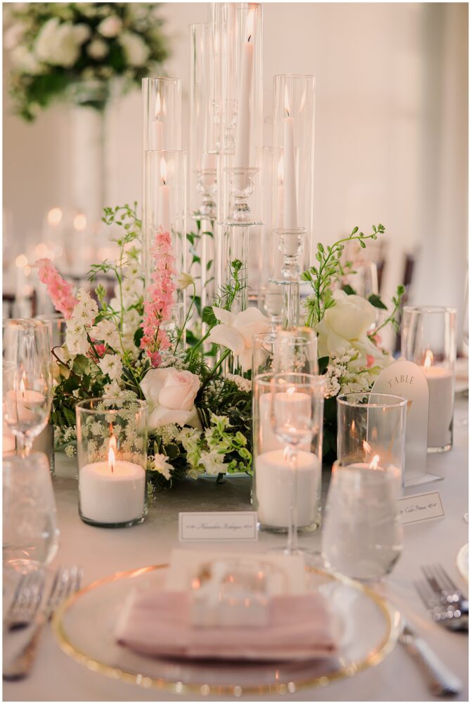 Elegant wedding table with candles and floral centerpiece.