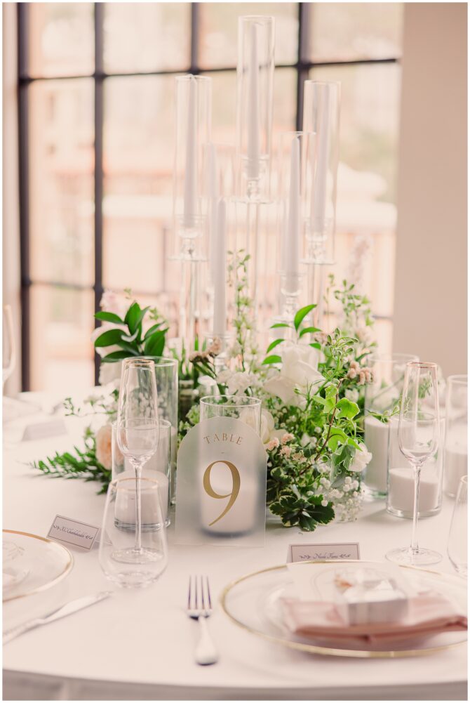 Elegant table setting with floral centerpiece and candles.