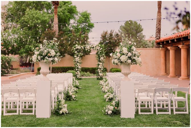 Outdoor wedding ceremony setup with floral decorations.