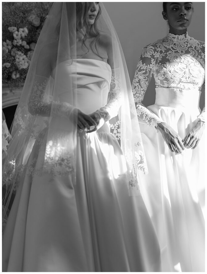 Two women in elegant wedding dresses, lace details.