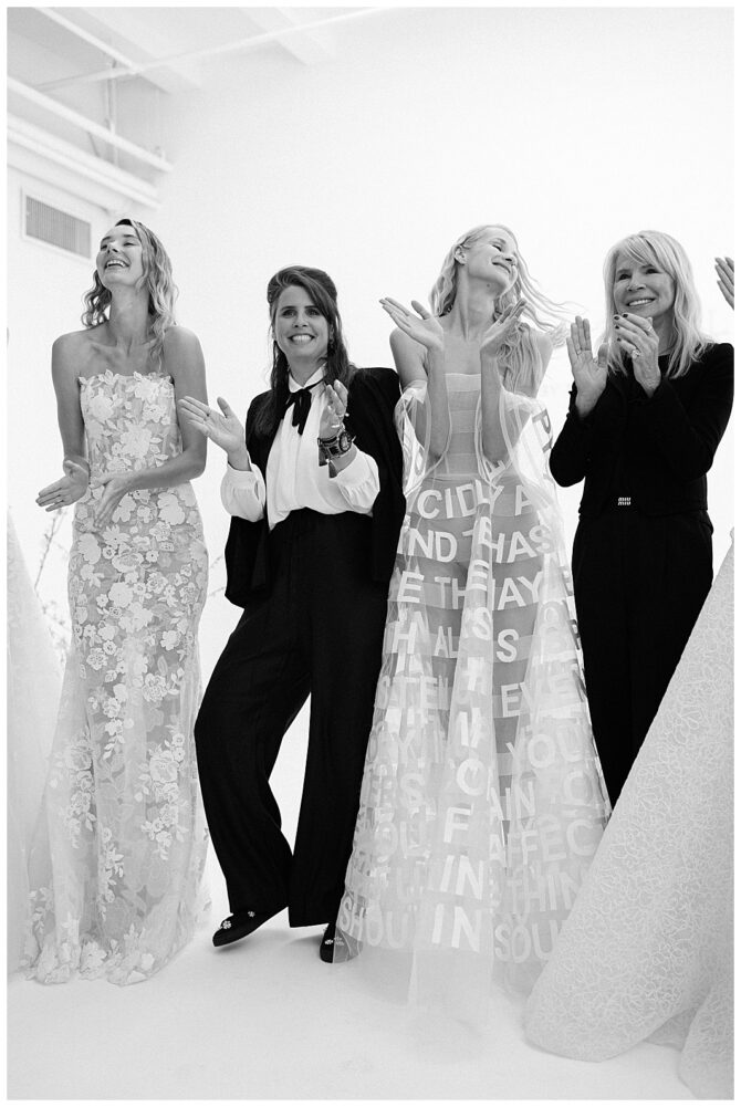 Women in elegant dresses applauding at event