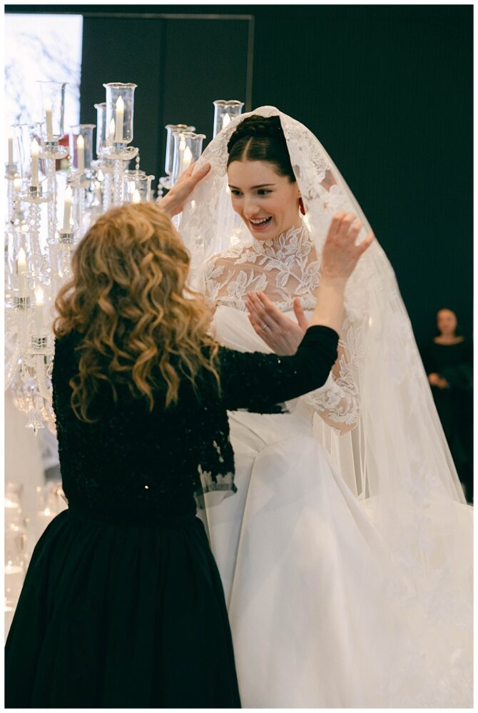 Bride in lace dress with assistant