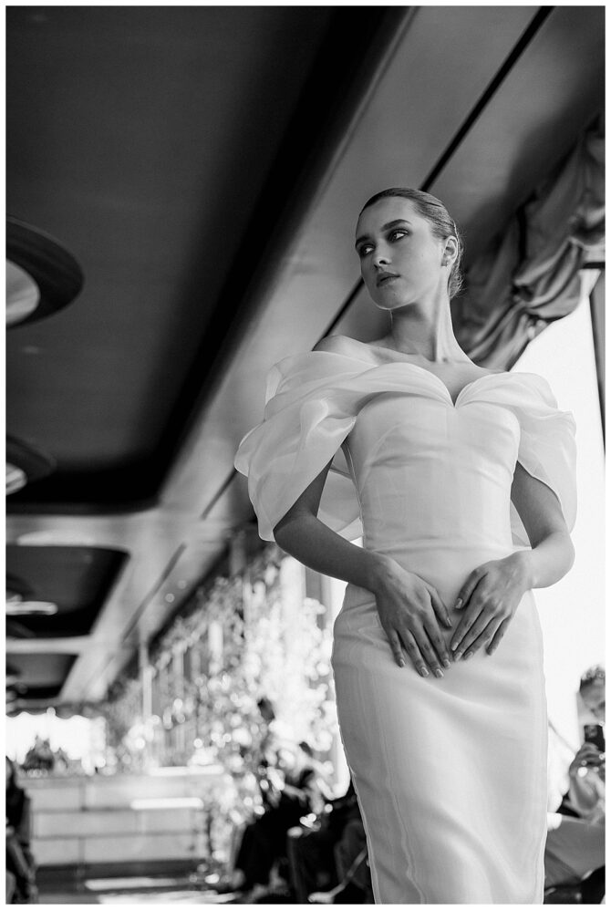 Model in elegant white gown on runway