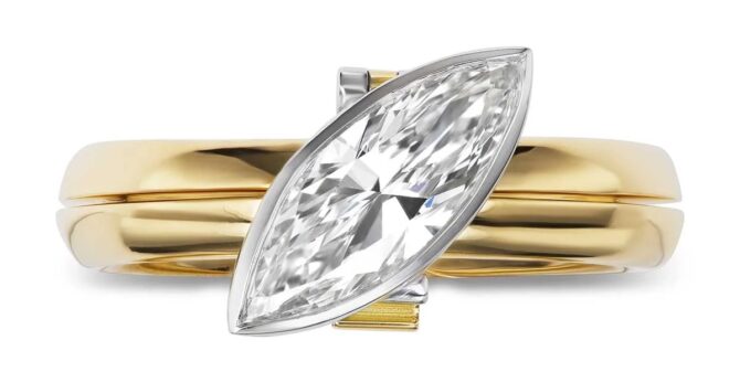Gold ring with marquise-cut diamond center.